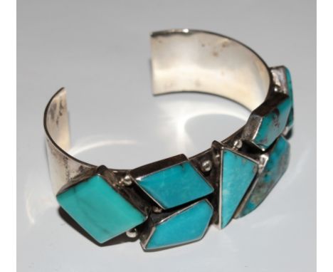 A silver and turquoise bangle