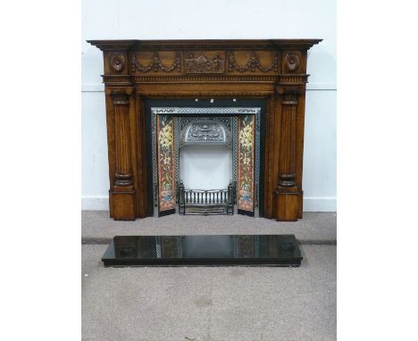 Complete fireplace comprising heavy carved oak fire surround (W165cm x H133cm) with Art Nouveau style cast iron inset with fl