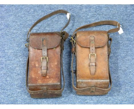Two vintage leather Ammunition Pouches, of curved rectangular form with leather straps, brass buckles and fittings, 12in (30.