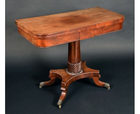 A Regency mahogany D-shaped card table, folding top enclosing an inset baize lined playing surface, above a deep frieze centr