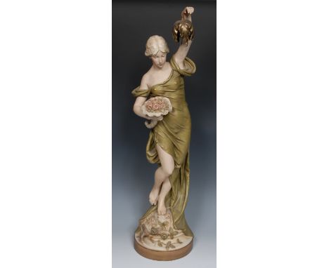 A Royal Dux table lamp, modelled as a maiden, scantily draped, with cornucopia of flowers in one hand and the other held alof