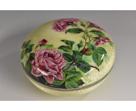 A large early 20th century silver and enamel bun shaped box and cover, decorated in polychrome with roses on a pale lemon eng