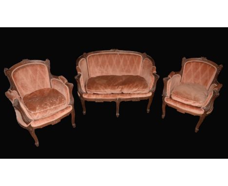 A Louis XV Revival walnut salon suite, comprising a small sofa and a pair of armchairs, outswept scroll arms, cabriole legs, 