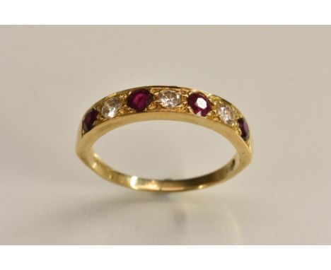 A ruby and diamond half eternity ring, alternate set with four red rubies and three round brilliant cut diamonds, total estim