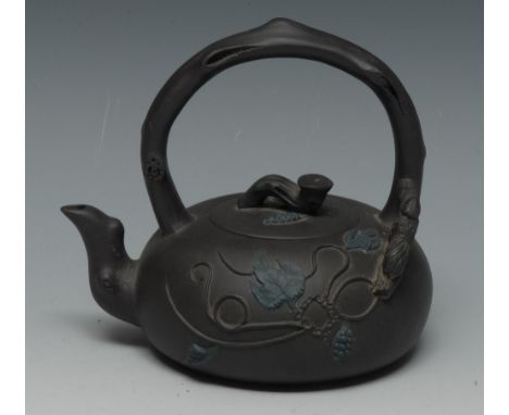 A Chinese Yixing Duan Ni tea kettle, of small proportions, moulded in high relief with scrolling leafy stems, arched branch h