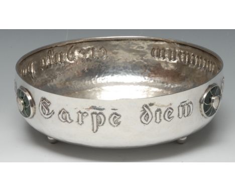 An Arts and Crafts silver and enamel circular bowl, embossed with verse Carpe diem quam minimum credula postero and applied w