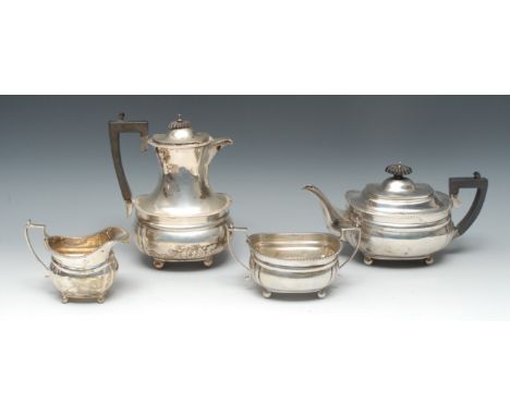 A George V silver four piece boat shaped tea service, comprising teapot, water jug, milk jug and sugar basin, gadrooned borde