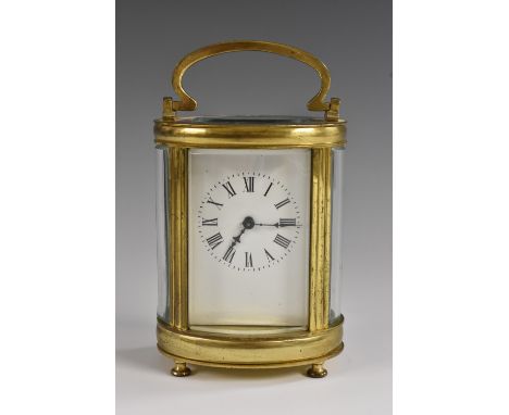 A late 19th century French lacquered brass oval carriage timepiece, 6cm white enamel dial with Roman numerals, key-wound move