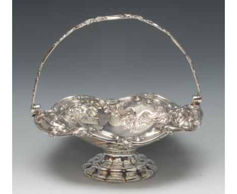 An early Victorian silver shaped circular swing-handled pedestal cake dish, embossed with scrolling acanthus and diapers, flu