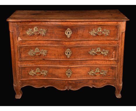 An 18th century French Provincial fruitwood serpentine commode, moulded oversailing top above three long drawers, gilt rococo