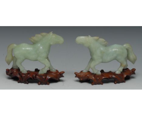 A pair of jade horses, 12cm high,  on stands