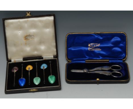 A pair of Edwardian silver wick scissors, 14cm long, Sheffield 1904, cased; a set of six George VI silver and enamel coffee s