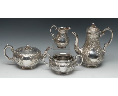 A composed Victorian silver four piece tea and coffee service, comprising teapot, coffee pot, milk jug and sugar basin, profu