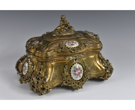 A 19th century French gilt metal and enamelled table box, by Taham, Paris, of bombe serpentine form, set with oval panels of 