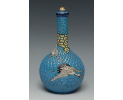 A Japanese Satsuma bottle vase and stopper, moulded in relief with scales and cranes in flight, on a turquoise ground, 21cm h