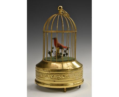 A 19th century style musical bird cage automaton, the singing avian perched on a branch, brass cage and base, keyless movemen