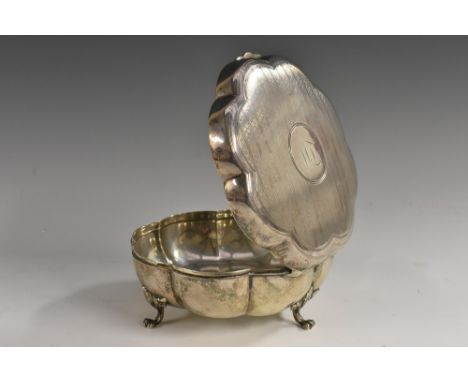 An Edwardian silver melon shaped casket, hinged engine turned cover, lion paw feet with acanthus to knees, 12cm diam, Daniel 