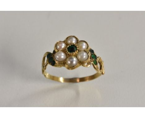 A 19th century emerald and pearl flower head cluster ring, central rough cut emerald, surrounded by six half pearls, between 