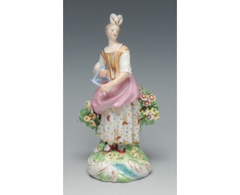 A Derby Patch figure, of a musician, she stands playing the triangle, wearing feathers in her hair, peach and gilt bodice, pi
