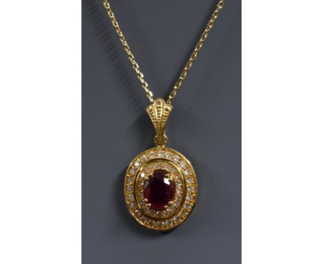 A ruby and diamond oval pendant necklace, central oval red ruby approx 0.85ct, surrounded by forty four round brilliant cut d
