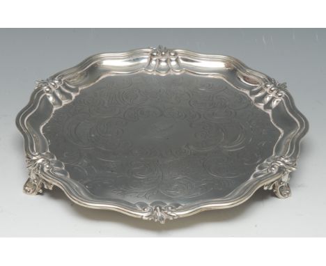 An early Victorian silver shaped circular salver, fluted scroll and stiff leaf border, the field chased and engraved with scr