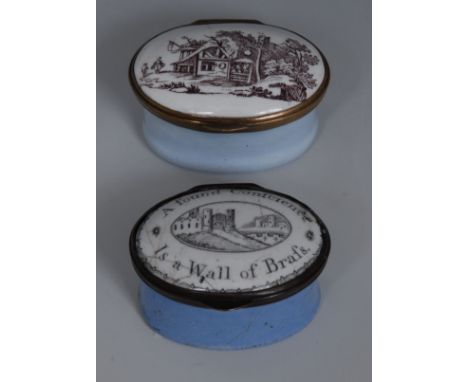 A South Staffordshire enamel oval patch box, the cover enamelled in sepia with rustic cottage, light blue sides, 4.5cm wide, 