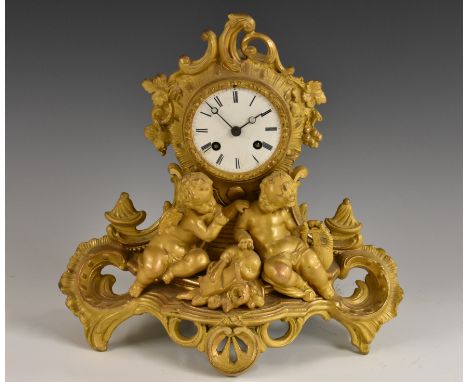 A 19th century gilt metal mantel clock, 8cm circular enamel dial inscribed with Roman numerals, twin-winding holes, fourteen-