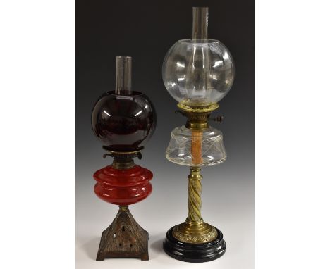 A Victorian brass oil lamp, globular clear ridged shade above clear cut glass reservoir, brass floral twisting column, four l