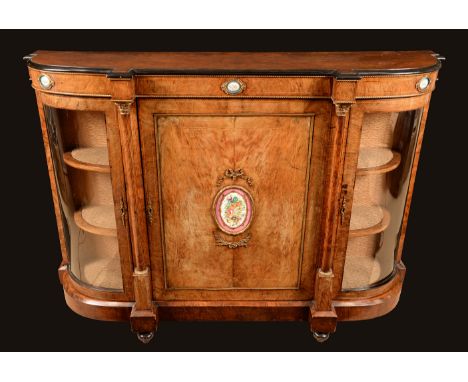A Victorian gilt metal and porcelain mounted walnut credenza, moulded top above a rectangular door, the mounts painted in the
