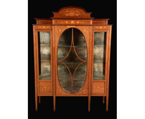 A late Victorian mahogany and marquetry display cabinet, arched cresting above an oval glazed door, flanked by a pair of furt