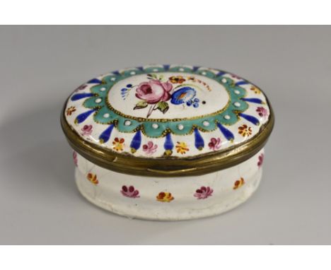 A George III South Staffordshire enamel oval patch box, the hinged cover centred by a spray of country flowers painted in ton