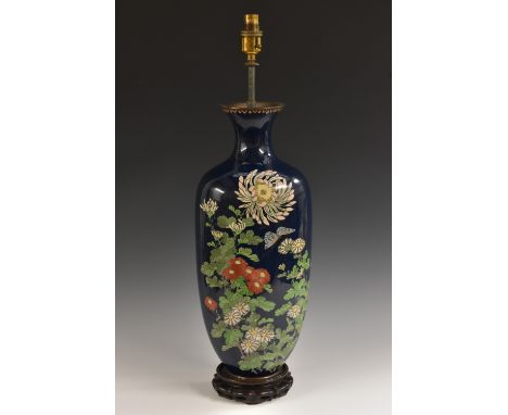 A Japanese cloisonné enamel vasular table lamp, decorated with white chrysanthemums, red zinnia and green foliage on a dark b