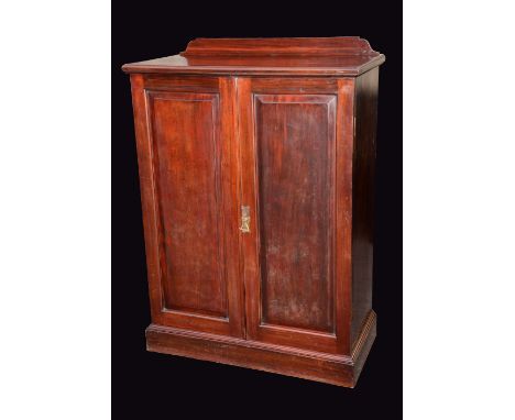 A Victorian walnut gentleman's bedroom cabinet, by Howard & Sons Ltd, London, raised and fielded panel doors, enclosing three