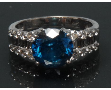 A blue and white diamond ring, principle natural fancy blue round brilliant cut diamond, measuring approx 8.86mm x 8.92mm x 5