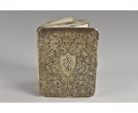 An American silver pocket photograph frame, engraved with scrolling foliage, hinged cover enclosing two oval apertures, the i