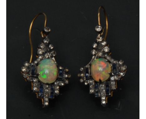 A pair of Art Deco opal diamond and sapphire  drop earrings, each with a central oval cabochon opal, flashing green, violet, 