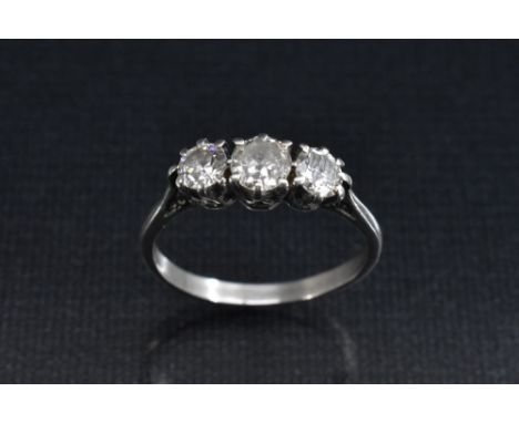 A diamond  trilogy ring, linear set with three round old brilliant cut diamonds, central diamond approx 0.30ct, total estimat