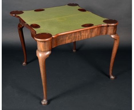 A George II Irish mahogany hipped rectangular concertina-action card table, folding top enclosing counter wells and inset bai