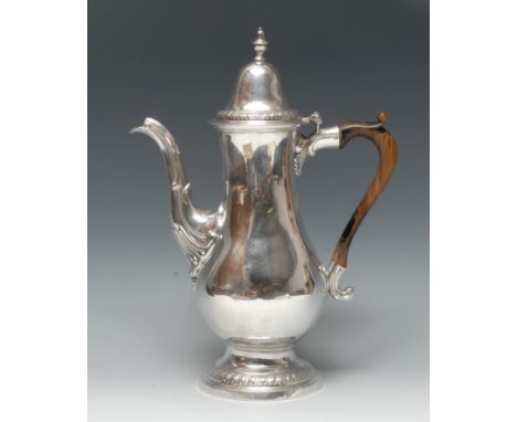 A George III Provincial silver baluster coffee pot, hinged domed lofty cover with knop finial, gadrooned borders, fruitwood s