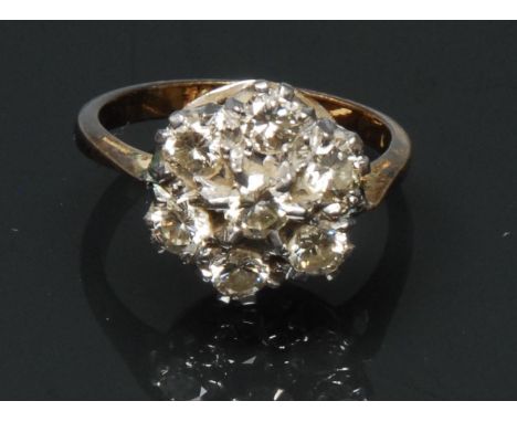 A diamond floral cluster ring, central raised old round brilliant cut diamond approx 0.18ct, above a surrounding band of six 