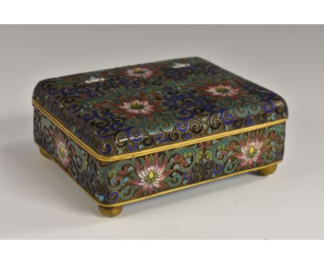 A Chinese cloissoné enamel rounded rectangular table casket, decorated with flowering peonies and a field of scrolls in tones