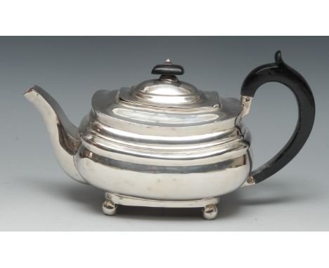 A George III silver boat shaped teapot, flush-hinged domed cover, ebonised finial and scroll-capped handle, bun feet, 26.5cm 