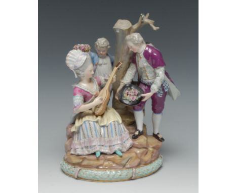 A Meissen figure group, Under the Tree, modelled with musical lovers by a tree trunk, he leaning towards her offering her flo