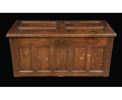 An early 18th century oak rectangular blanket chest, four panel top, five panel front, 63cm high, 134cm wide