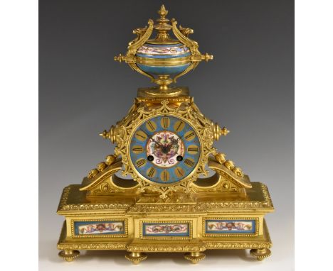 A 19th century French porcelain mounted gilt metal mantel clock, 10cm circular dial inscribed with Roman numerals, twin windi