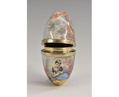 A 19th century Continental silver and enamel egg shaped bonbonniere, painted in polychrome with a young lady gathering flower