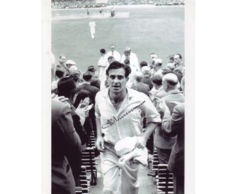  Fred Trueman: 8x10 inch photo signed by the late Freddie Trueman, pictured leaving the field after becoming the first bowler