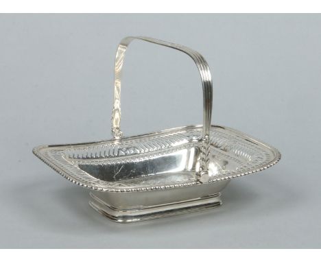 An Edwardian silver pierced cake basket with reeded swing handle by Henry Atkin. Assayed Sheffield 1904. 739 grams, 25cm x 21