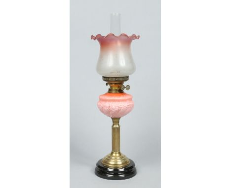 A Victorian brass based oil lamp with Duplex burner. Having opaque cranberry blush font and cranberry tint etched glass shade