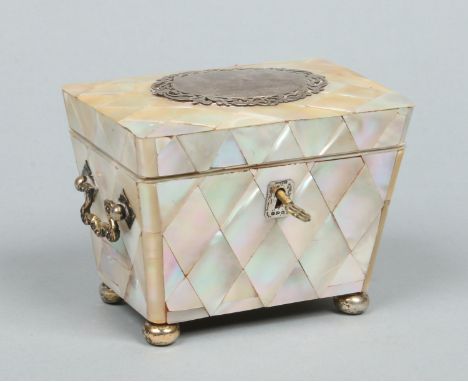 A Victorian parquetry inlaid mother of pearl tea caddy. With silver and silver gilt mounts, twin drop handles and raised on s